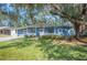 Charming ranch home with a manicured lawn and mature trees at 1632 Tangerine St, Lakeland, FL 33803