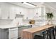 Renovated kitchen featuring white shaker cabinets, butcher block countertops, and breakfast bar at 1632 Tangerine St, Lakeland, FL 33803
