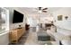 Living room with view into updated kitchen, wood floors, and large TV at 1632 Tangerine St, Lakeland, FL 33803