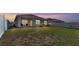 Large backyard with lawn, patio, grill and white fence at 1878 Pristine Loop, Lakeland, FL 33811