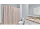 Bathroom with a shower curtain, granite counters, and white cabinets at 1878 Pristine Loop, Lakeland, FL 33811