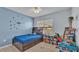 Bedroom with carpet, plane decals, window, and brown bookcase bed frame at 1878 Pristine Loop, Lakeland, FL 33811
