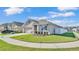 Landscaped home exterior with a well-kept lawn and a white fence, providing privacy and curb appeal at 1878 Pristine Loop, Lakeland, FL 33811