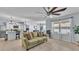 Bright open-concept living area with a large fan, neutral colors, and lots of natural light at 1878 Pristine Loop, Lakeland, FL 33811