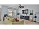Comfortable living room featuring a neutral color scheme and large television at 1878 Pristine Loop, Lakeland, FL 33811