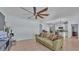 Open-concept living area with tile floors adjacent to the kitchen with barstool seating at 1878 Pristine Loop, Lakeland, FL 33811