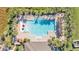 Top-down shot of a resort-style swimming pool featuring lounge chairs and colorful umbrellas at 1878 Pristine Loop, Lakeland, FL 33811