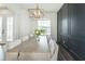 Modern dining room with a large table, chandelier, and gray wall at 1936 Deep Creek Dr, Lakeland, FL 33810