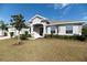 Single-story house with gray exterior, stone accents, and two-car garage at 1936 Deep Creek Dr, Lakeland, FL 33810