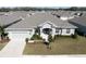 Single-story house with gray exterior, landscaping, and two-car garage at 1936 Deep Creek Dr, Lakeland, FL 33810