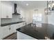 Modern kitchen with a large island, white cabinets and black countertops at 1936 Deep Creek Dr, Lakeland, FL 33810