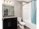Clean bathroom with dark vanity and a teal shower curtain at 1958 Altavista Cir, Lakeland, FL 33810
