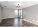 Bright bedroom with wood-look floors and a modern chandelier at 1958 Altavista Cir, Lakeland, FL 33810