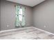 Bright bedroom featuring light gray walls and wood-look flooring at 1958 Altavista Cir, Lakeland, FL 33810