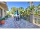 Relaxing community patio with tables, umbrellas, and lush tropical plants at 1958 Altavista Cir, Lakeland, FL 33810