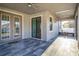 Covered patio with tile floors and French doors at 1958 Altavista Cir, Lakeland, FL 33810