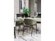 Modern dining area with green chairs and marble floors at 1958 Altavista Cir, Lakeland, FL 33810