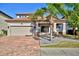 Two-story house with tile roof and paver driveway at 1958 Altavista Cir, Lakeland, FL 33810