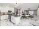 Spacious kitchen boasts modern white cabinets, a large island, and marble flooring at 1958 Altavista Cir, Lakeland, FL 33810