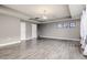Large living room with wood-look floors and multiple windows at 1958 Altavista Cir, Lakeland, FL 33810