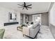 Open living room with fireplace, gray sofa, and marble floors at 1958 Altavista Cir, Lakeland, FL 33810