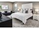 Main bedroom with plush carpet, king bed, and gray sofa at 1958 Altavista Cir, Lakeland, FL 33810
