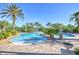 Community pool with palm trees and lounge areas at 1958 Altavista Cir, Lakeland, FL 33810