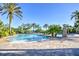 Community pool with palm trees and lounge areas at 1958 Altavista Cir, Lakeland, FL 33810