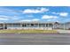 Front view of a gray manufactured home with a paved driveway at 2055 S Floral Ave # 235, Bartow, FL 33830