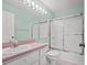 Updated bathroom with pink vanity and shower at 2348 Isle Royale Se Ct, Winter Haven, FL 33880