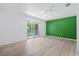 Bedroom with balcony access and laminate wood floors at 2348 Isle Royale Se Ct, Winter Haven, FL 33880