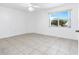 Bright bedroom featuring tile floors and a large window at 2348 Isle Royale Se Ct, Winter Haven, FL 33880
