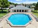 Relaxing community pool with surrounding lounge chairs at 2348 Isle Royale Se Ct, Winter Haven, FL 33880