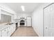 Kitchen with white cabinets, granite countertops, and stainless steel appliances at 2348 Isle Royale Se Ct, Winter Haven, FL 33880