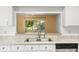 Kitchen with white cabinets, granite countertops, and stainless steel appliances at 2348 Isle Royale Se Ct, Winter Haven, FL 33880