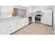 Kitchen with white cabinets, granite countertops, and stainless steel appliances at 2348 Isle Royale Se Ct, Winter Haven, FL 33880