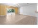 Living room with tiled floors and sliding glass doors to a screened porch at 2348 Isle Royale Se Ct, Winter Haven, FL 33880