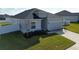 Single-story house with a gray exterior, two-car garage, and a neat lawn at 252 Walkers Point Dr, Auburndale, FL 33823