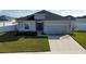 Single-story house with gray exterior, two-car garage, and well-manicured lawn at 252 Walkers Point Dr, Auburndale, FL 33823
