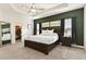 Main bedroom with a dark brown platform bed and green accent wall at 252 Walkers Point Dr, Auburndale, FL 33823