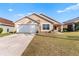 Tan house with white garage door and stone accents at 2752 Rochelle Dr, Winter Haven, FL 33881