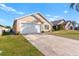 Tan house with white garage door and stone accents at 2752 Rochelle Dr, Winter Haven, FL 33881