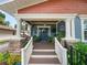 Inviting front porch with wooden steps and swing at 304 E Palm Dr, Lakeland, FL 33803