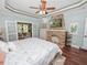 Main bedroom with fireplace, wood floors, and large bed at 304 E Palm Dr, Lakeland, FL 33803