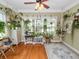 Sunroom with hardwood floors, many plants, and a fish tank at 304 E Palm Dr, Lakeland, FL 33803