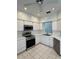 Modern kitchen with stainless steel appliances, white cabinets and tile flooring at 3133 Stonewater Dr # 3133, Lakeland, FL 33803