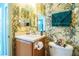 Small bathroom with a single vanity and floral wallpaper at 4128 Aberdeen Ln, Lake Wales, FL 33859