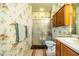 Bathroom with seashell wallpaper, shower, and wood vanity at 4128 Aberdeen Ln, Lake Wales, FL 33859