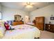 Bright bedroom with wood furniture, ceiling fan, and a floral comforter at 4128 Aberdeen Ln, Lake Wales, FL 33859