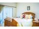 Cozy bedroom with wood furniture and a cheerful yellow and floral bedding set at 4128 Aberdeen Ln, Lake Wales, FL 33859